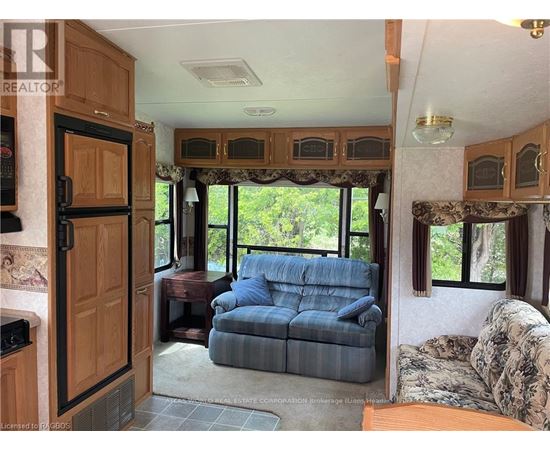 A living room with a couch and a window.