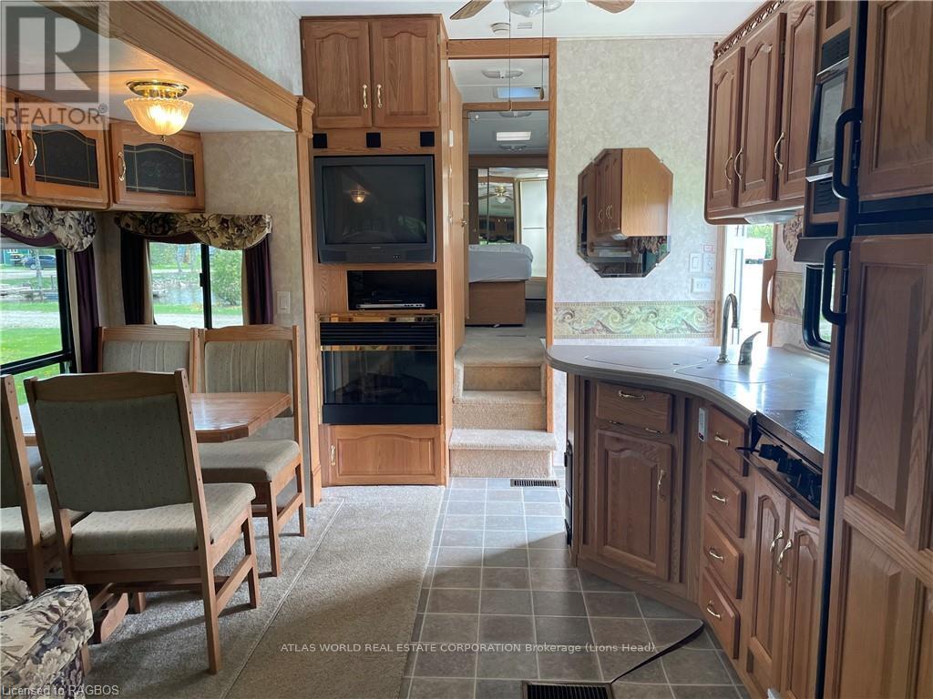 A kitchen with wooden cabinets and a black stove top oven.