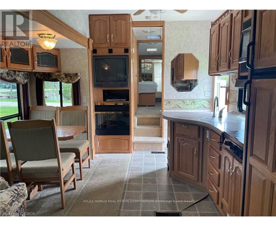 A kitchen with wooden cabinets and a black stove top oven.