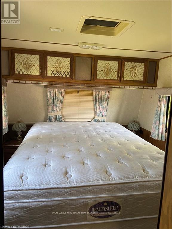 A bed with a BeautySleep mattress label on it.