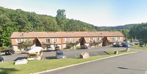 A large building with a parking lot in front of it.