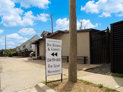 A sign for Don Knobler & Company for lease management stands in front of a building.