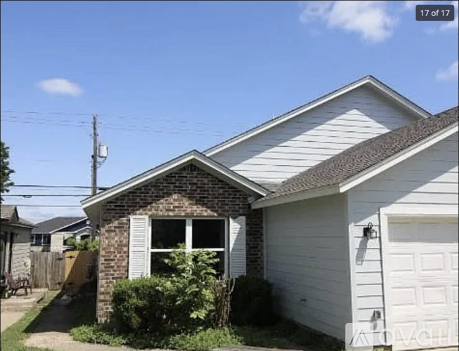 A house with a white garage door and a brick chimney.