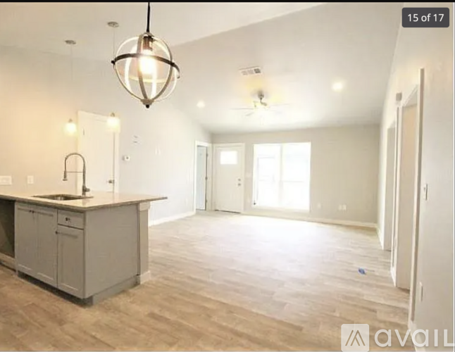 A kitchen area with a counter and cabinets is available for rent.