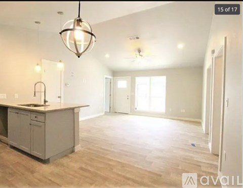 A kitchen area with a counter and cabinets is available for rent.
