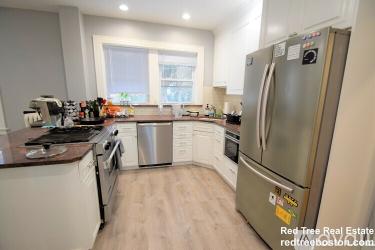 A kitchen with a refrigerator, stove, and oven.