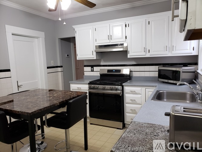 A kitchen with a table and chairs and a stove.