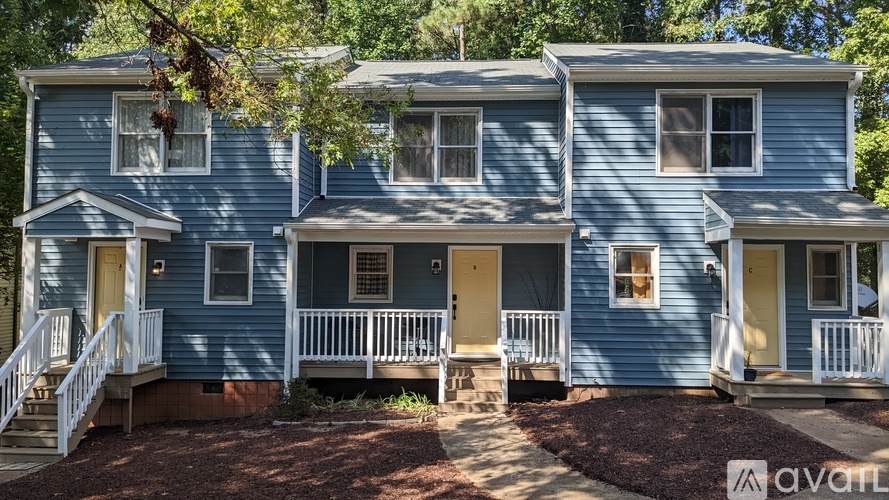 A blue two-story house with a front porch.