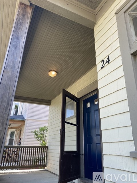 A black door with a glass window is on the front of a house.