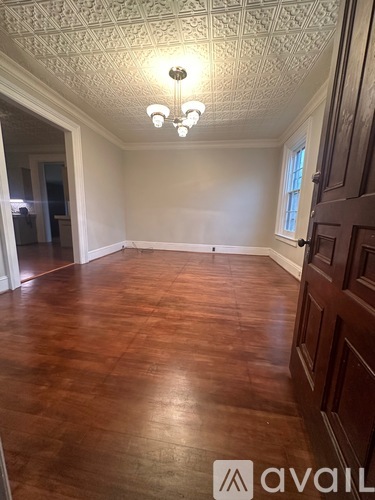 A room with wooden floors and a chandelier.