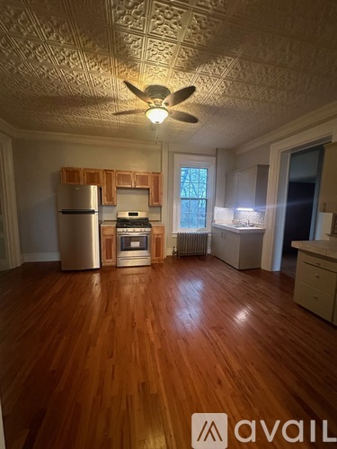 A room with wooden floors and a ceiling fan.