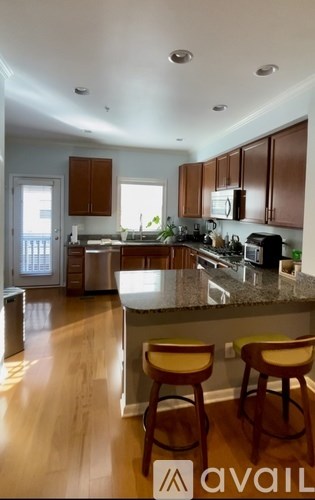 A kitchen with wooden cabinets and a granite countertop.