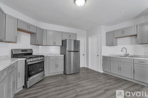 A kitchen with a stove, refrigerator, and cabinets.