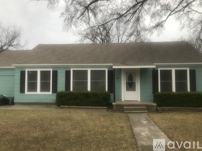 A house with a blue exterior and a white door.