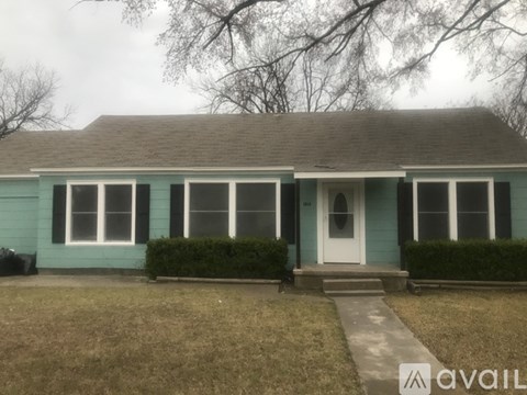 A house with a blue exterior and a white door.