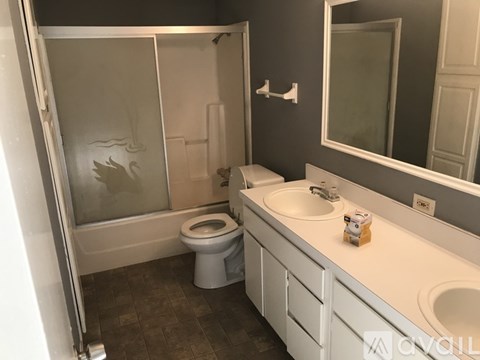 A bathroom with a toilet, sink, and shower.