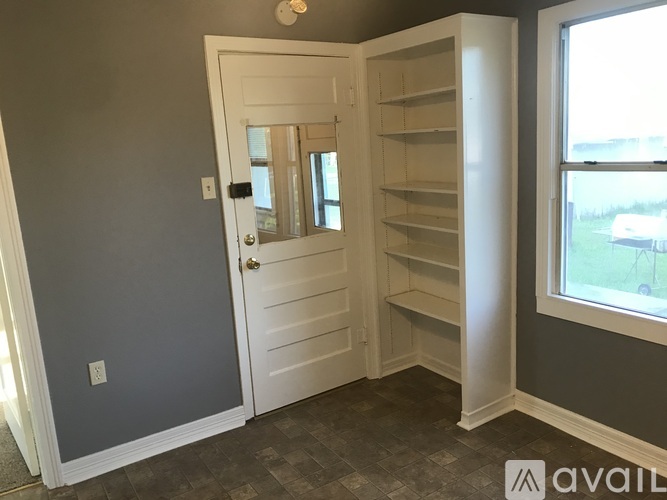A room with a white door and a window.
