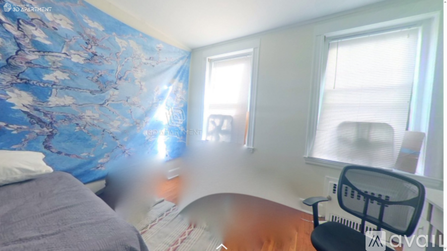 A room with a bed, a chair, and a desk.