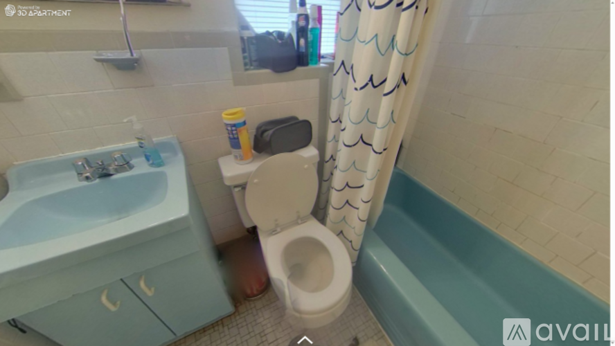 A bathroom with a toilet, sink, and bathtub.