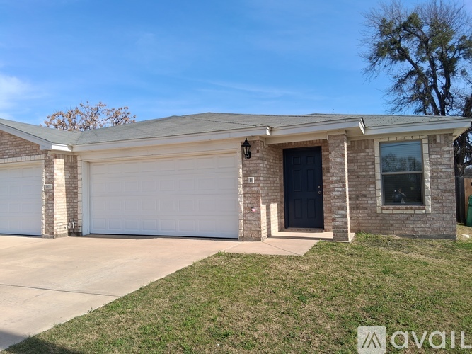 A house with a garage door and a driveway.