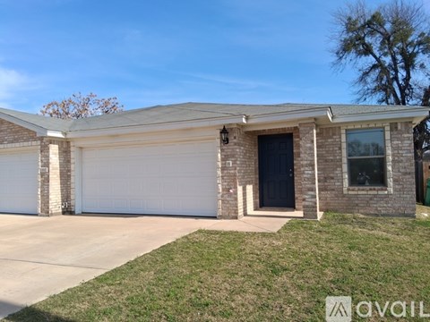 A house with a garage door and a driveway.