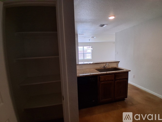A kitchen area with a counter and cabinets is available.