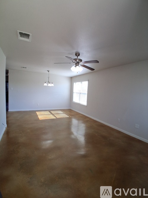 A room with a ceiling fan and a window.