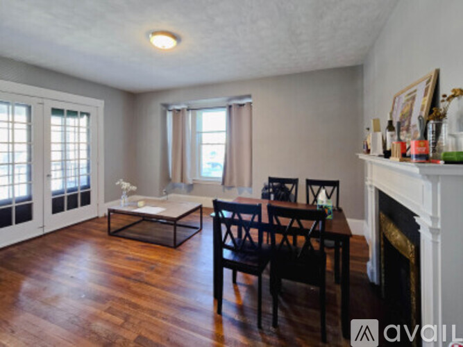 A living room with a couch, coffee table, and a window.