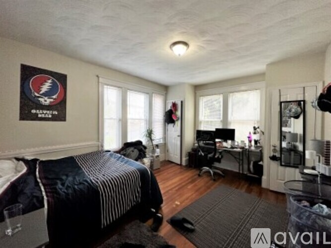A bedroom with a Grateful Dead poster on the wall.