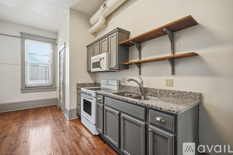 A kitchen with a granite countertop and stainless steel appliances.