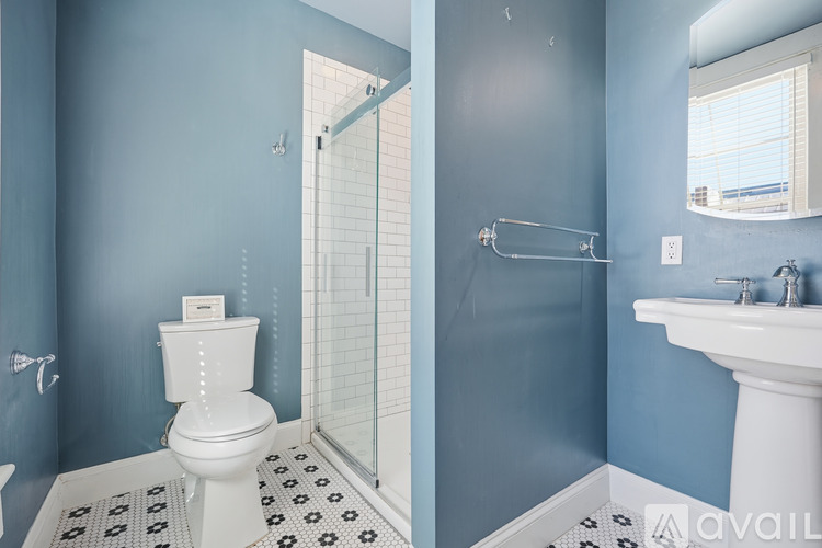 A bathroom with a white toilet and a white sink.