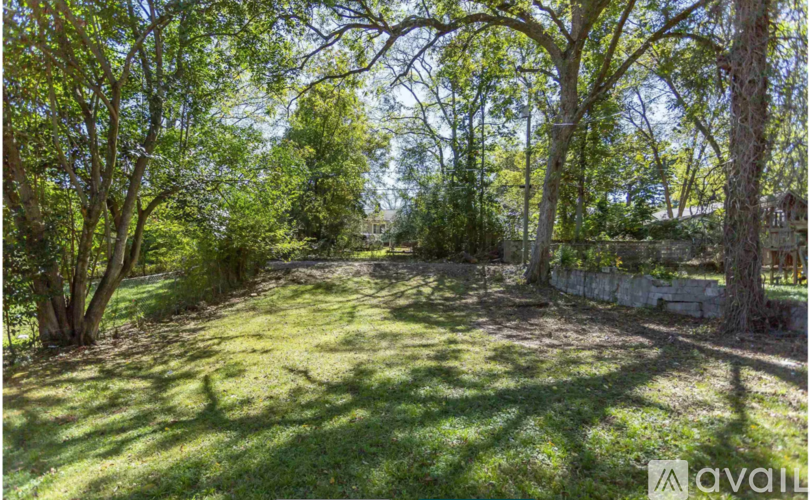 A backyard with a lawn and trees.