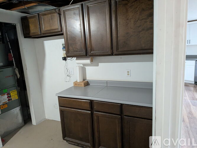 A kitchen with brown cabinets and a white fridge.