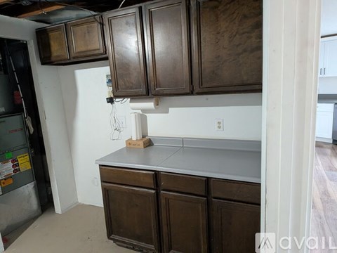 A kitchen with brown cabinets and a white fridge.