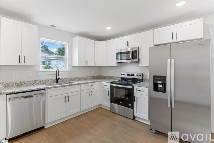 A kitchen with white cabinets and stainless steel appliances.