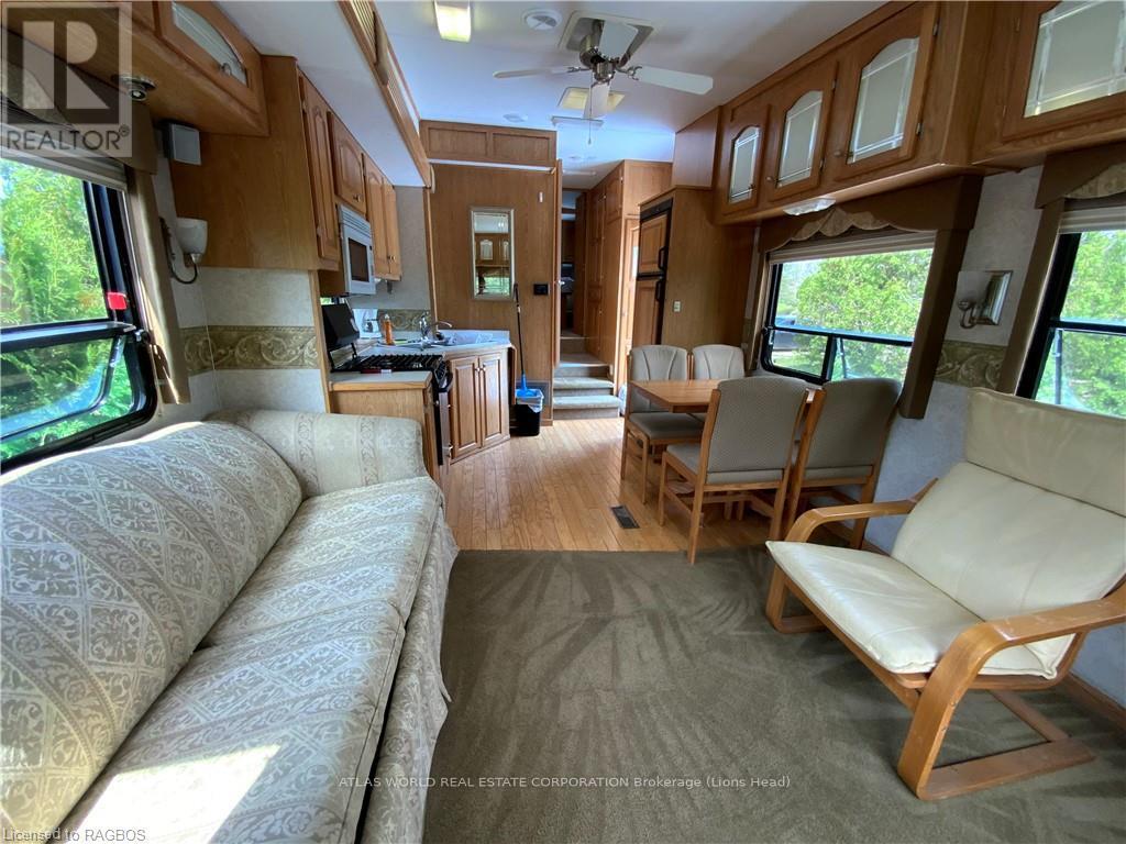 A living room with a couch and chairs is shown.