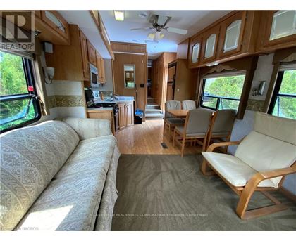 A living room with a couch and chairs is shown.