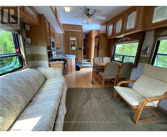 A living room with a couch and chairs is shown.