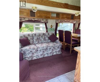 A living room with a couch and chairs.
