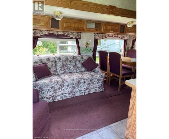 A living room with a couch and chairs.