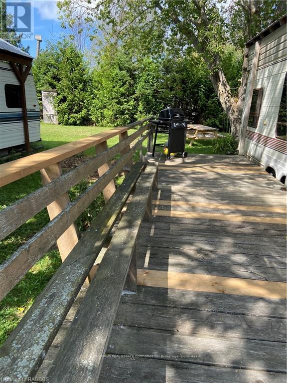A wooden fence runs along the side of a concrete walkway.