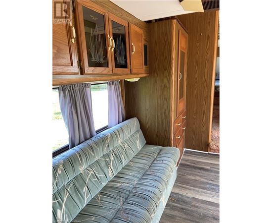 A living room with a couch and wooden cabinets.