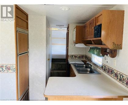 A kitchen with a sink and a refrigerator.