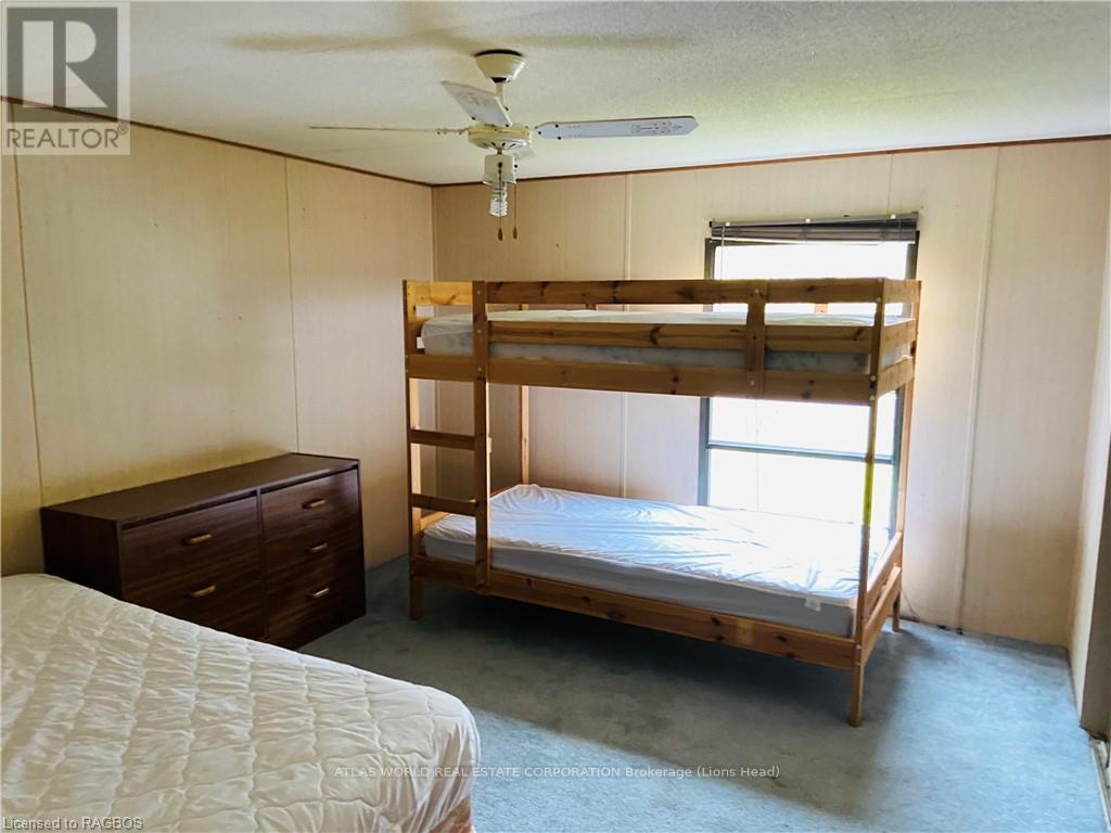 A bedroom with a bunk bed and a single bed.