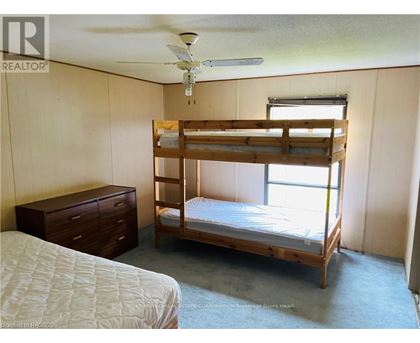 A bedroom with a bunk bed and a single bed.