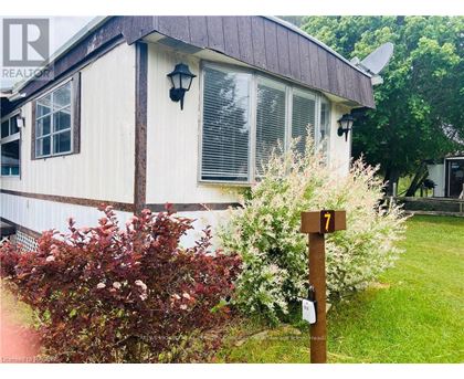 A house with a brown roof and a sign that says 7.