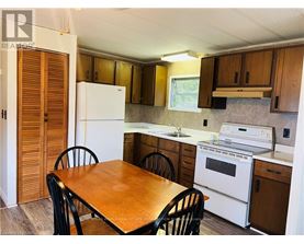 A kitchen with a table and chairs.