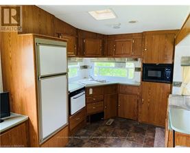A kitchen with wooden cabinets and a white refrigerator.