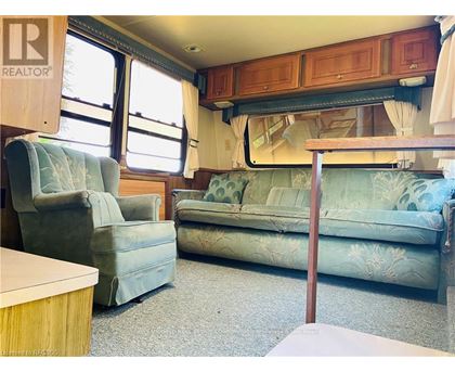 A living room with a couch, chair, and table.