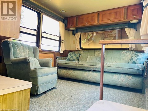 A living room with a couch, chair, and table.